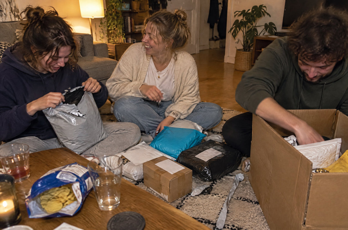 Friends opening mystery parcels at home (lifestyle illustration)